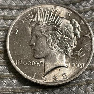 1923-P UNCIRCULATED CONDITION PEACE SILVER DOLLAR AS PICTURED.