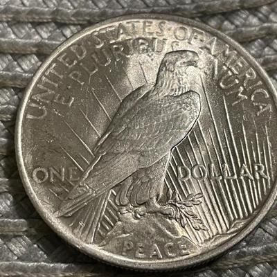 1923-P UNCIRCULATED CONDITION PEACE SILVER DOLLAR AS PICTURED.