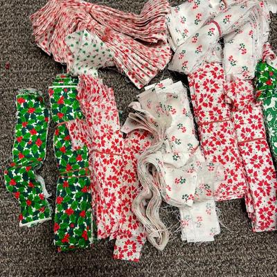 Lot of Christmas Holiday Print Material cut into stripes and squares, and other shapes for quilting