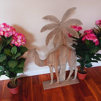 FREE STANDING WOODEN CAMEL AND 2 FAUX FLOWERING PLANTS