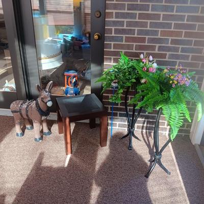 CERAMIC DONKEY YARD ART, 2 IRON PLANT STANDS AND A PLASTIC PATIO TABLE