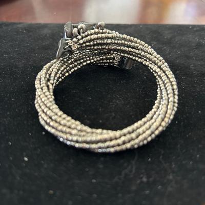 Silver tone beaded with black designs wire bracelet