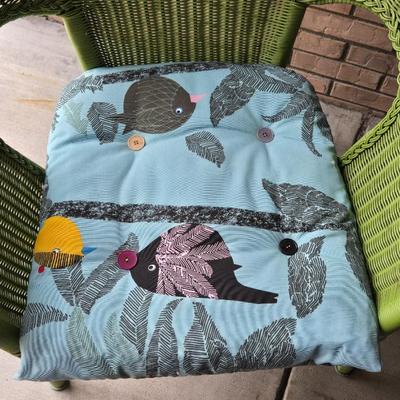 Green Wicker Style Chair with MulticoloredBird Cushion