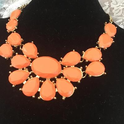 Coral colored gems on GT necklace