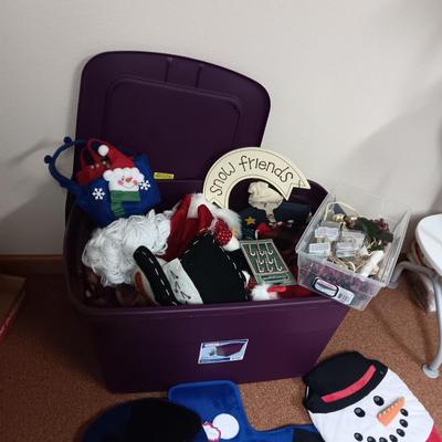TOILET SEAT COVERS AND A TOTE FULL OF OTHER CHRISTMAS DECORATIONS