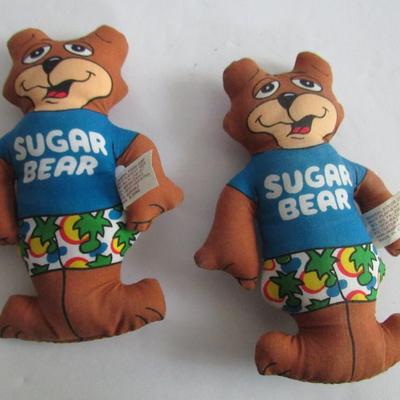 2 Kelloggs Toy Trucks, 2 Sugar Bear Dolls, Old Chalk Box With Small Chalk Pieces