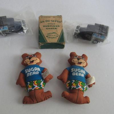 2 Kelloggs Toy Trucks, 2 Sugar Bear Dolls, Old Chalk Box With Small Chalk Pieces