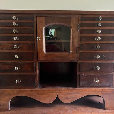 Antique Harvard Style Dental/Jewelry Cabinet with Crystal Knobs 33" Wide & 26" Tall in Good Preowned Condition.