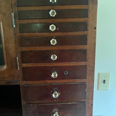 Antique Harvard Style Dental/Jewelry Cabinet with Crystal Knobs 33" Wide & 26" Tall in Good Preowned Condition.