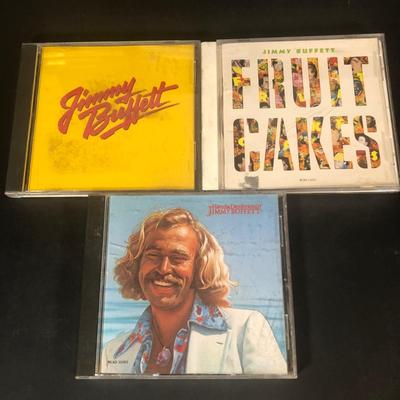 LOT 39L: Collection of CDs w/ 2 CD Racks - Jimmy Buffett, Andrea Bocceli, Johnny Mathis & More