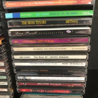 LOT 39L: Collection of CDs w/ 2 CD Racks - Jimmy Buffett, Andrea Bocceli, Johnny Mathis & More
