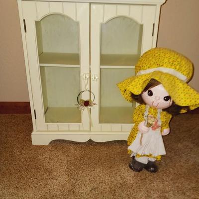 SWEET LITTLE DISPLAY CABINET, A WICKER CHAIR AND A PAPER MACHE DOLL