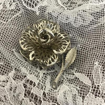 Rose-shaped silver tone filigree brooch marked Lisener