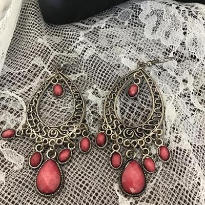 Silver tone earrings with pink teardrop gems