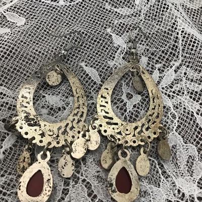 Silver tone earrings with pink teardrop gems