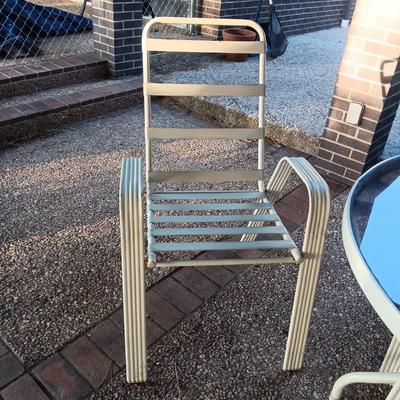 ROUND GLASS TOP PATIO TABLE WITH 4 CHAIRS AND 2 ADDITIONAL STACKING CHAIRS