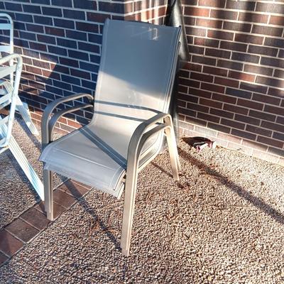 ROUND GLASS TOP PATIO TABLE WITH 4 CHAIRS AND 2 ADDITIONAL STACKING CHAIRS