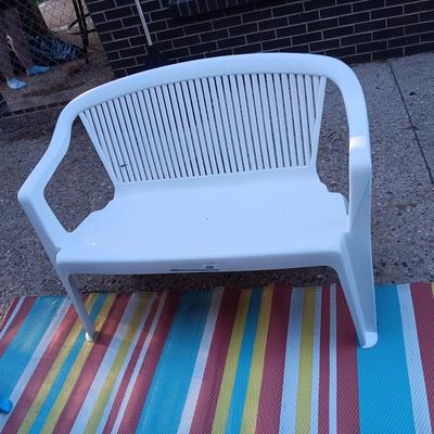 2 PLASTIC BENCHES AND 2 ADIRONDACK CHAIRS PLUS AN OUTDOOR RUG