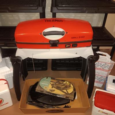 LIKE NEW THERMOS GRILL TO GO PLUS SEVERAL COOLERS AND A FOLDING CHAIR