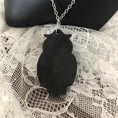 Black wooden owl charm on silver tone necklace