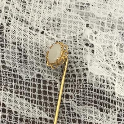 Gold toned flower with white gem vintage pin
