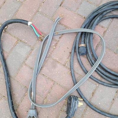 A four prong and a three prong dryer cord and a heavy duty extension cord