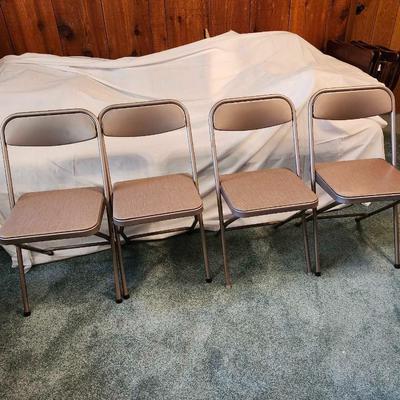 Four Samsonite folding chairs with vinyl seats