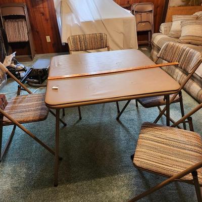 four Cosco folding chairs with vintage cloth seats and folding table