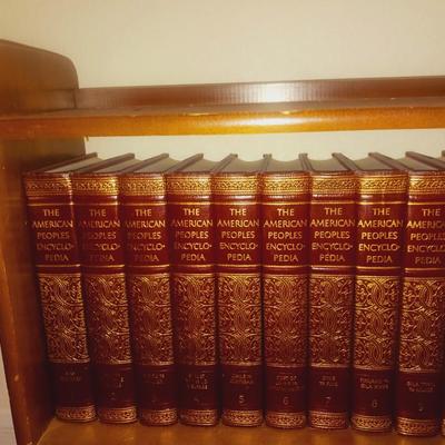 SMALL BOOKCASE FILLED WITH ENCYCLOPEDIAS