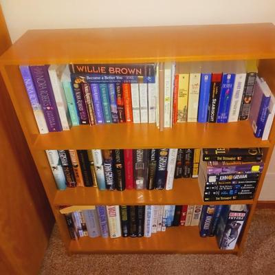 SMALL BOOK CASE FILLED WITH A VARIETY OF BOOKS