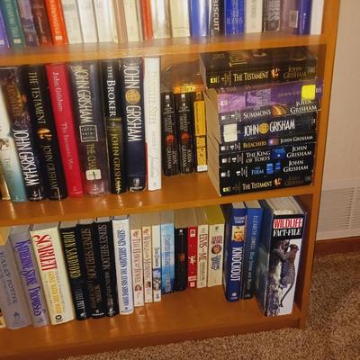 SMALL BOOK CASE FILLED WITH A VARIETY OF BOOKS