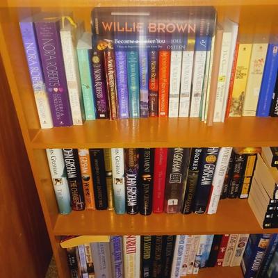 SMALL BOOK CASE FILLED WITH A VARIETY OF BOOKS
