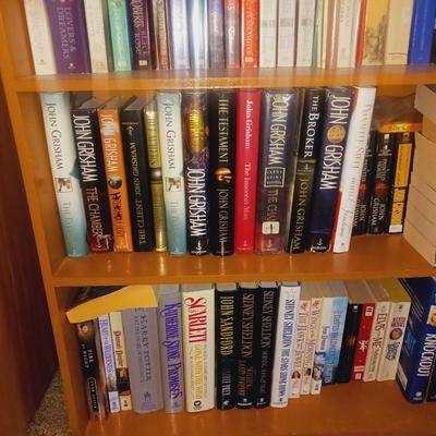 SMALL BOOK CASE FILLED WITH A VARIETY OF BOOKS