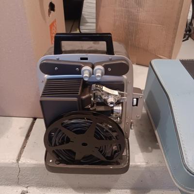 BELL & HOWELL MOVIE PROJECTER AND A CALCULATOR