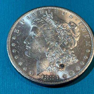 1884-O BU CONDITION MORGAN SILVER DOLLAR AS PICTURED.