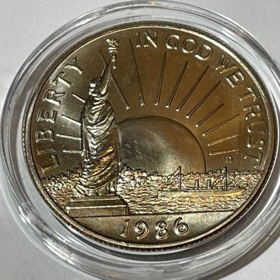 1986-D CHOICE BU Statue of Liberty Commemorative Half Dollar in a Mint Capsule.
