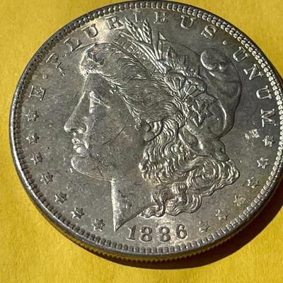 1886-P NICELY TONED REVERSE UNCIRCULATED MORGAN SILVER DOLLAR AS PICTURED.