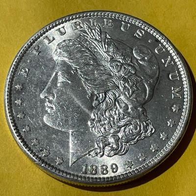 1889-P NICE UNCIRCULATED MORGAN SILVER DOLLAR AS PICTURED.