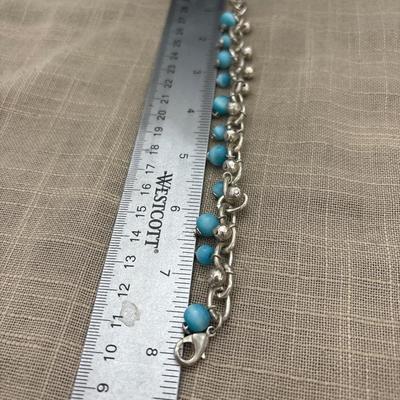 Light blue beads on silver tone charm bracelet