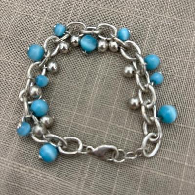 Light blue beads on silver tone charm bracelet