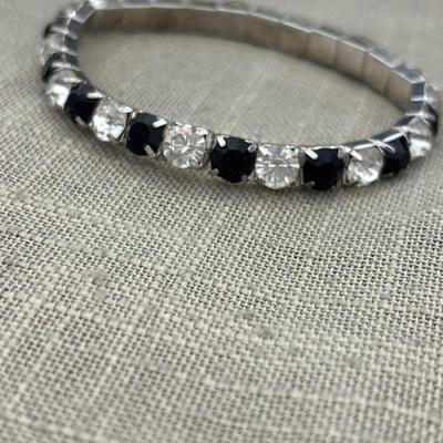 Black and silver rhinestones on silver tone charm stretchy bracelet
