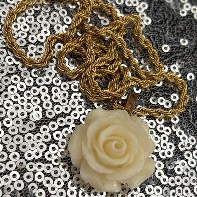 Celluloid rose pendant with gold toned chain