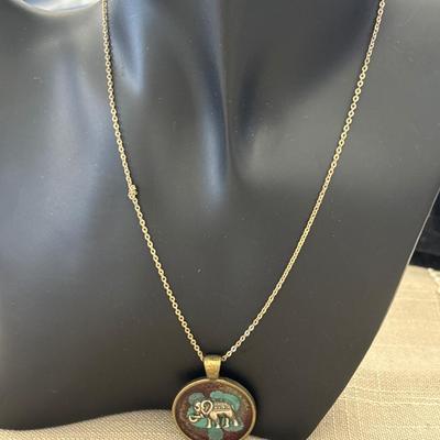 Gold toned necklace with elephant pendant