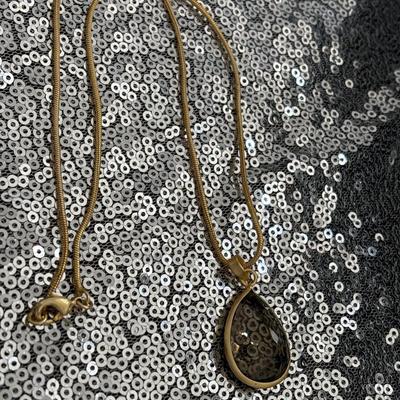 Smoky quartz crystal pendant with gold toned chain necklace