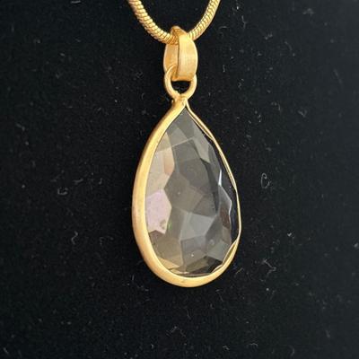 Smoky quartz crystal pendant with gold toned chain necklace