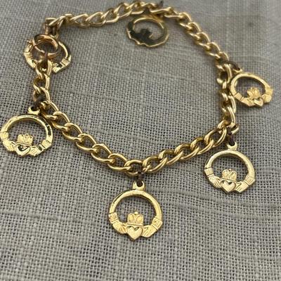Gold tone heart and hands charm bracelet