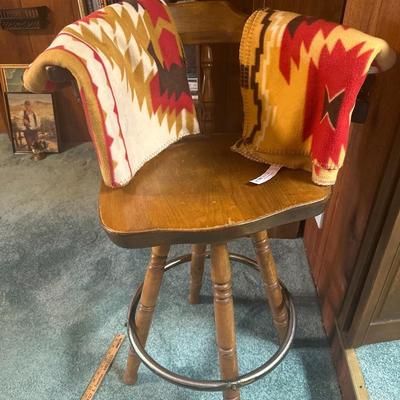 wooden bar barrel stool and two thrown blankets