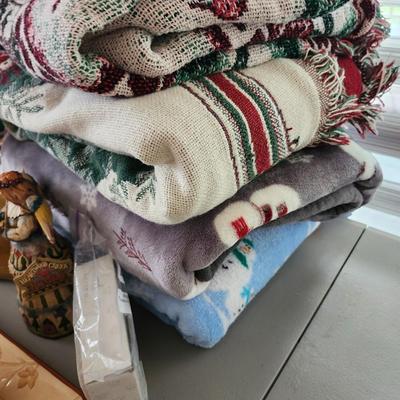 Christmas lot with thrown blankets and Bin