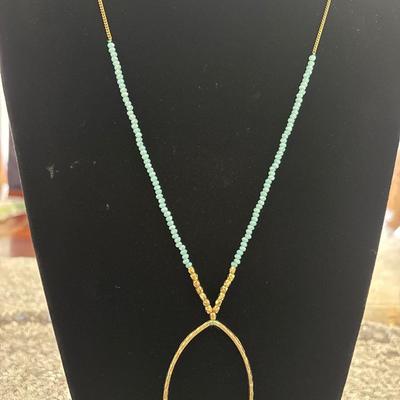 Gold toned Long chain with turquoise, crystal beads, and Gold toned pendant