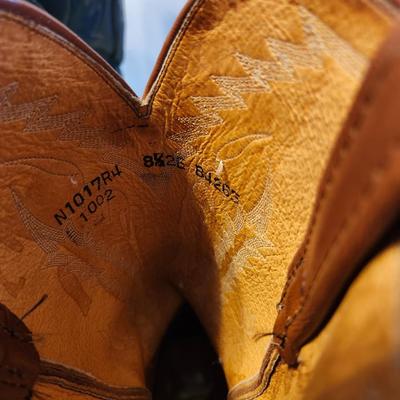 Three Pair of cowboy boots and Boot brush